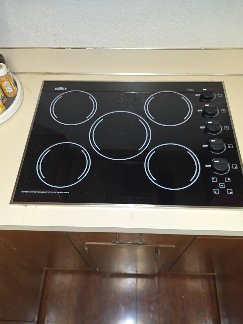 Summit five-burner ceramic cooktop set into a laminate counter, element test in progress