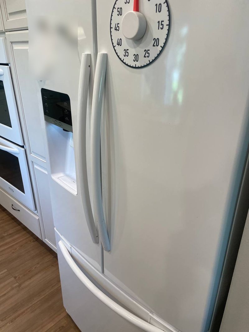 White French-door refrigerator with a bottom freezer in a South Capitol kitchen, cooling check underway