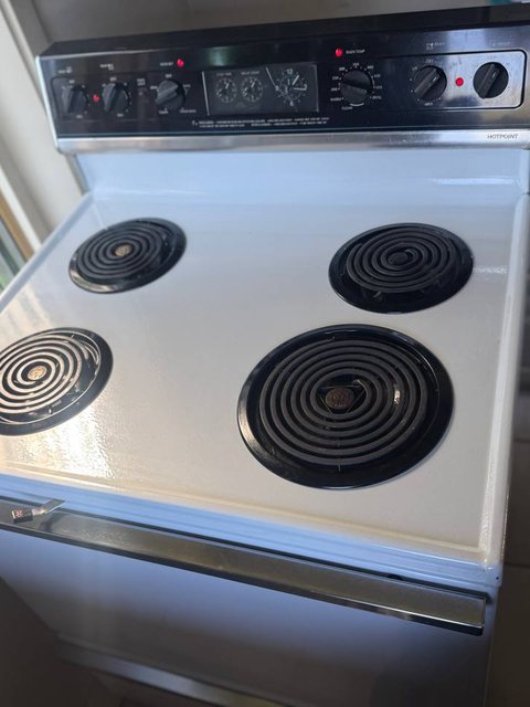 Hotpoint electric range top with four coil burners, oven thermostat checked